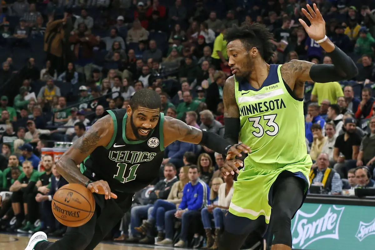 Point guard Celtics Kyrie Irving menerobos pertahanan Timberwolves di laga NBA