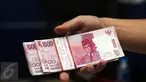 Petugas memperlihatkan barang bukti uang palsu pecahan Rp 100.000,- saat rilis di Bareskrim Mabes Polri, Gedung KKP, Jakarta, Senin (10/10). Peredaran dikendalikan dari rutan, empat tersangka diamankan dalam kasus ini. (Liputan6.com/Helmi Fithriansyah)
