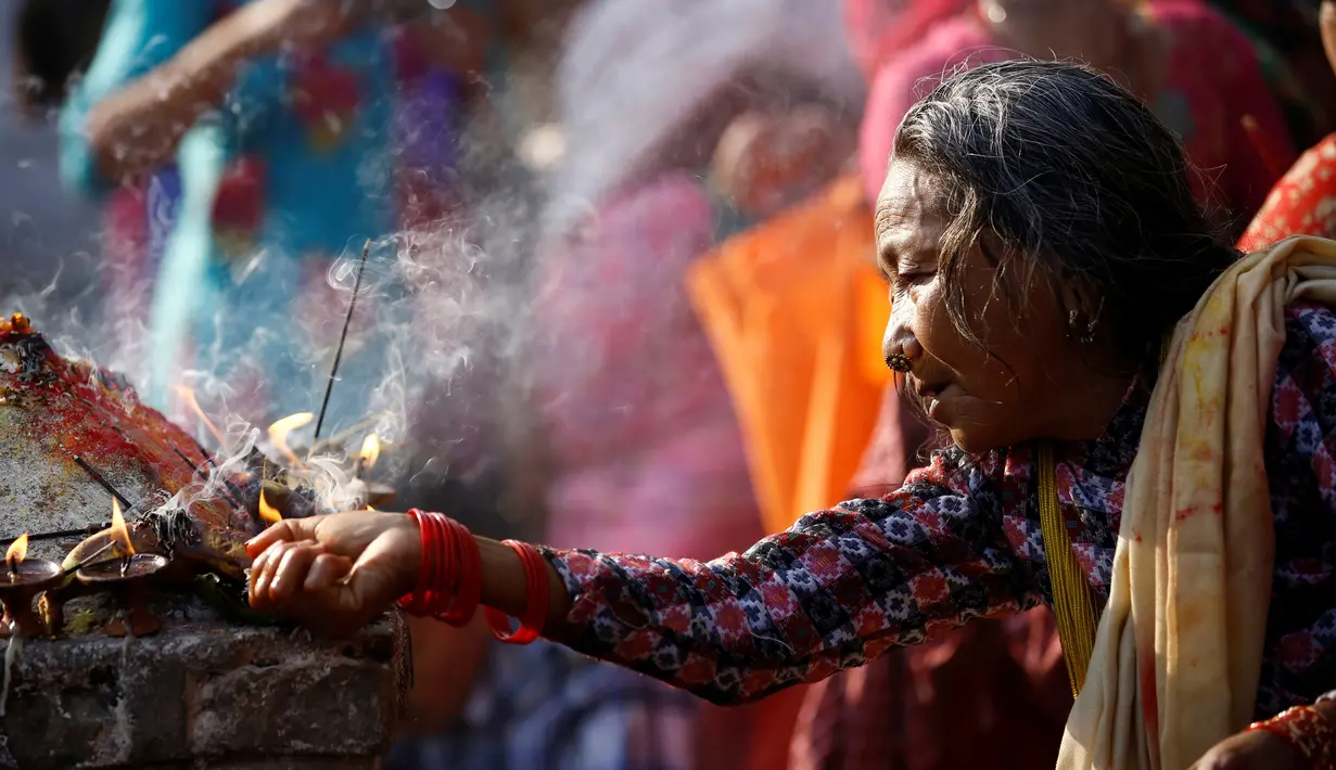 Seorang umat berdoa di Matatirtha Nepal, 6 Mei, 2016. Ritual yang digelar berupa menyajikan sesajen dan mandi bersama di sungai. (REUTERS / Navesh Chitrakar)