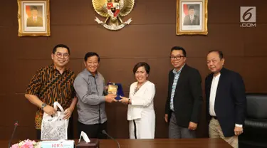 Direktur Program SCM Harsiwi Ahcmad memberi cindera mata kepada anggota Wantimpres Agum Gumelar di Jakarta, Jumat (18/5). Pertemuan ini merupakan silaturahmi sekaligus pengenalan program-program yang ada di SCM. (Liputan6.com/Angga Yuniar)