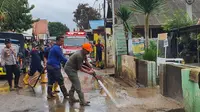 Warga bersama petugas membersihkan sisa lumpur banjir di Probolinggo. (Istimewa)