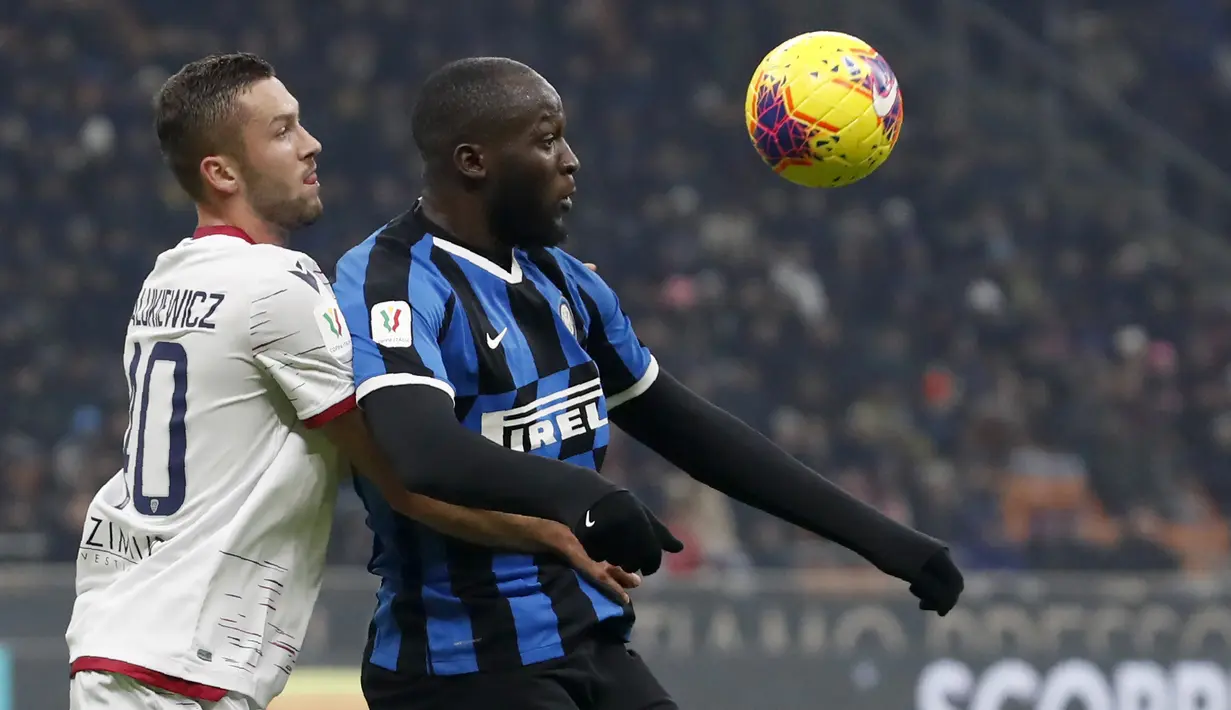 Striker Inter Milan, Romelu Lukaku, duel udara dengan pemain Cagliari, Sebastian Walukiewicz, pada laga Coppa Italia di Stadion Giuseppe Meazza, Rabu (15/1/2020). Inter Milan menang 4-1 atas Cagliari. (AP/Antonio Calanni)
