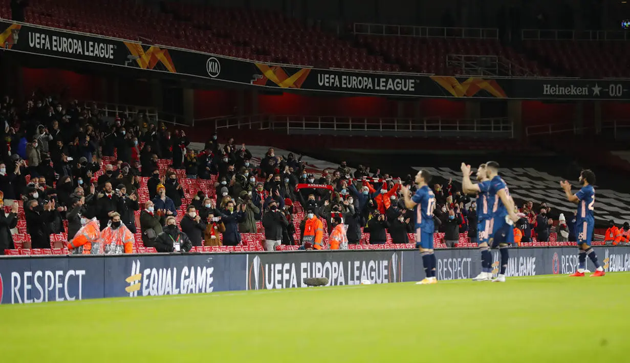 Penonton bertepuk tangan saat tim Arsenal dan Rapid Wien memasuki lapangan pada pertandingan Grup B Liga Europa di Emirates Stadium, London, Inggris, Kamis (3/12/2020). Arsenal menyegel status juara Grup B Liga Europa usai menaklukkan Rapid Wien 4-1. (AP Photo/Frank Augstein)