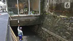 Petugas Dinas SDA memeriksa saluran air yang di atasnya berdiri bangunan di Kemang Utara, Jakarta, Rabu (17/11/2021). Wakil Gubernur DKI Ahmad Riza Patria menegaskan pendirian kafe maupun bangunan lainnya harus mengantongi izin sekaligus memenuhi prinsip tata ruang. (Liputan6.com/Herman Zakharia)