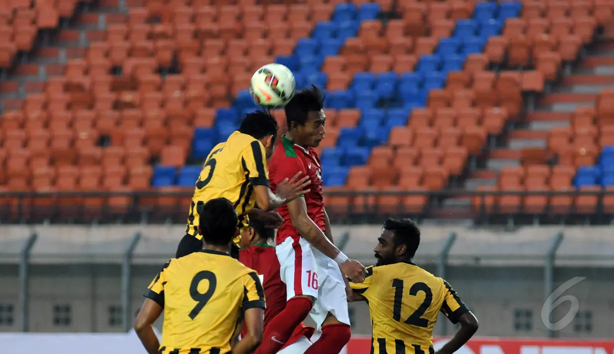 Bek Timnas Indonesia U-23, Hansamu Yama Pranata (16) berebut bola atas dengan M Syazwan Tajudin (Malaysia U-23) saat laga uji coba di Stadion Si Jalak Harupat, Bandung, Kamis (21/5/2015). Indonesia unggul 1-0. (Liputan6.com/Helmi Fithriansyah)