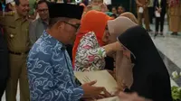 Gubernur Jawa Barat Ridwan Kamil membeirkan penghargaan dan santunan secara simbolis kepada beberapa beberapa ahli waris dari 49 petugas yang gugur di Aula Gedung Sate, Selasa (23/4/2019). (Huyogo Simbolon)