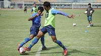 Duel Bayu Fiqri dan Frets Butuan saat sesi latihan Persib Bandung. (Bola.com/Erwin Snaz)