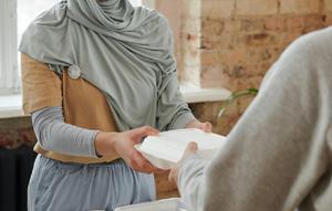 Salah satu contoh praktik amal sholeh sesuai hadits keutamaan memberi, muslimah bersedekah (Pexels)