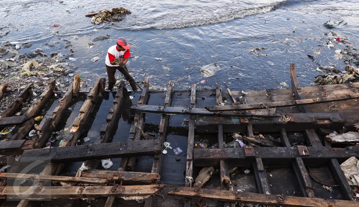 Warga tengah membongkar bangkai kapal di kawasan Kampung Nelayan Cilincing, Jakarta Utara Rabu (8/2). (Fery Pradolo/Liputan6.com)