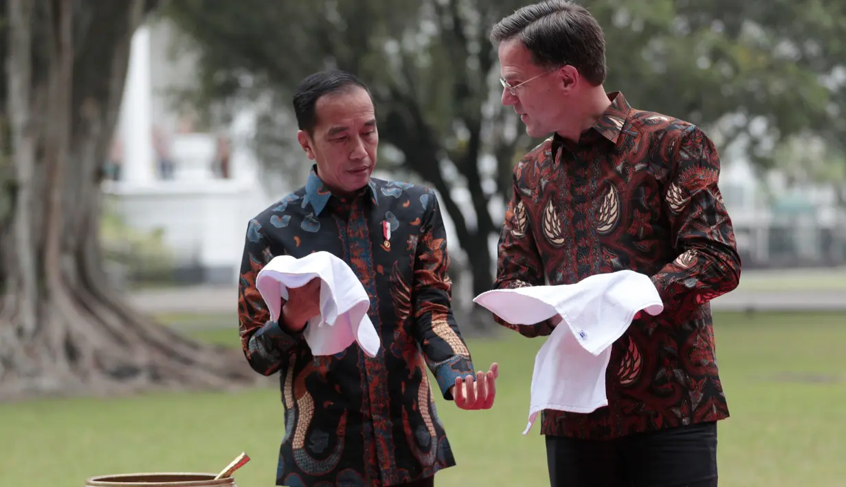 Presiden Joko Widodo (kiri) bersama PM Belanda Mark Rutte mengelap tangan usai menanam pohon damar di sela pertemuan di Istana Bogor, Senin (7/10/19). Pertemuan itu membahas kerja sama strategis antara Indonesia dan Belanda kedepan berdasarkan prinsip kemitraan komprehensif. (AP/Dita Alangkara)