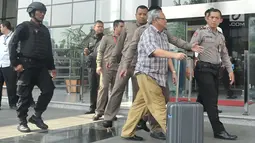 Kepala Dinas Pertanian Jatim, Bambang Heryanto dikawal petugas menuju gedung KPK untuk menjalani pemeriksaan, Jakarta (6/6). (Liputan6.com/Helmi Afandi)