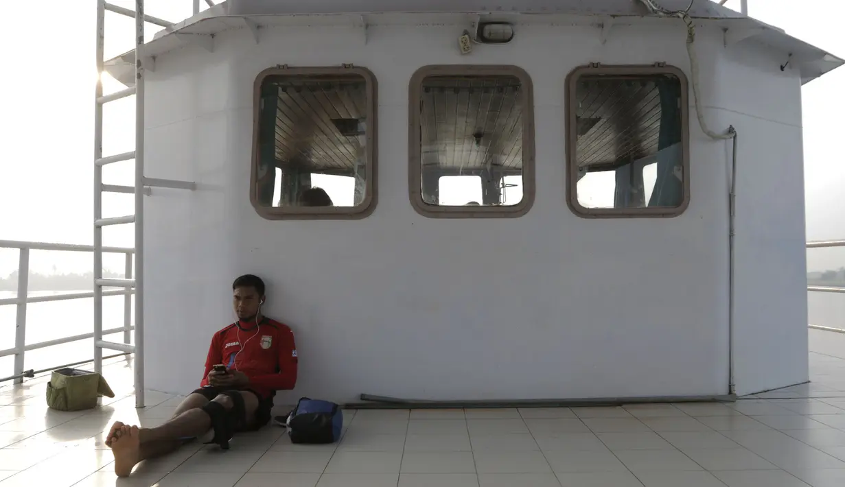 Pemain Mitra Kukar, Saepuloh menikmati perjalanan latihan menggunakan kapal feri menyeberangi Sungai Mahakam menuju Stadion Aji Imbut, Tenggarong, Kaltim, Sabtu (3/10/2015). (Bola.com/Vitalis Yogi Trisna)