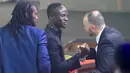 Penyerang Senegal, Sadio Mane (tengah) disambut oleh Djamel Belmadi (kanan) dari Algeria, pemenang Pelatih Terbaik, dan pelatih Senegal Aliou Cisse (kiri) setelah memenangkan penghargaan Pemain Terbaik Afrika 2019 selama CAF Awards di kota wisata Mesir, Hurghada (7/1/2020). (AFP/Khaled Desouki)