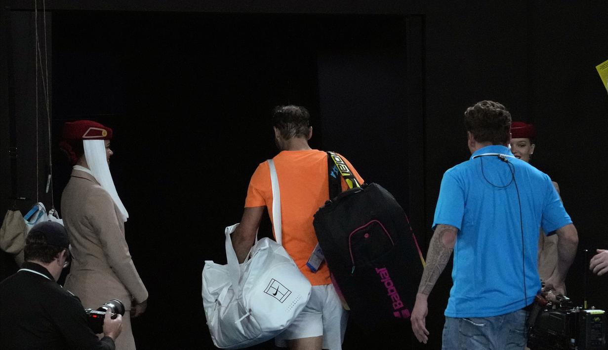 Petenis Spanyol, Rafael Nadal, meninggalkan lapangan usai ditaklukkan petenis Amerika Serikat, Mackenzie McDonald, pada Australian Open 2023 di Melbourne Park, Rabu (18/1/2023). Nadal kalah 6-4, 6-4, 7-5 dari Mackenzie. (AP Photo/Dita Alangkara)