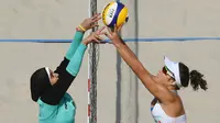 Penampilannya tampak kontras dengan tim lain yang ketika bertanding mengenakan bikini, seragam yang umumnya dipakai para atlet voli pantai. Sementara Doaa mengenakan busana tertutup, celana panjang, baju lengan panjang dan hijab. (Foto: AFP/Yasuyoshi Chiba)