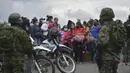 Kerabat narapidana berkumpul di luar penjara Turi tempat tentara berjaga-jaga setelah kerusuhan narapidana pecah di Cuenca, Ekuador (23/2/2021). Ratusan perwira dari unit taktis telah dikerahkan sejak bentrokan meledak.  (Boris Romoleroux/API via AP)