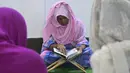 Anggota komunitas transgender belajar membaca Alquran di dalam Madrasah Dawatul Islam Tritio Linger untuk jenis kelamin ketiga, di Dhaka, Bangladesh, Selasa (17/11/2020). Ibu kota Bangladesh, Dhaka membuka madrasah pertama untuk transgender muslim pada 6 November 2020 lalu. (Munir Uz zaman/AFP)