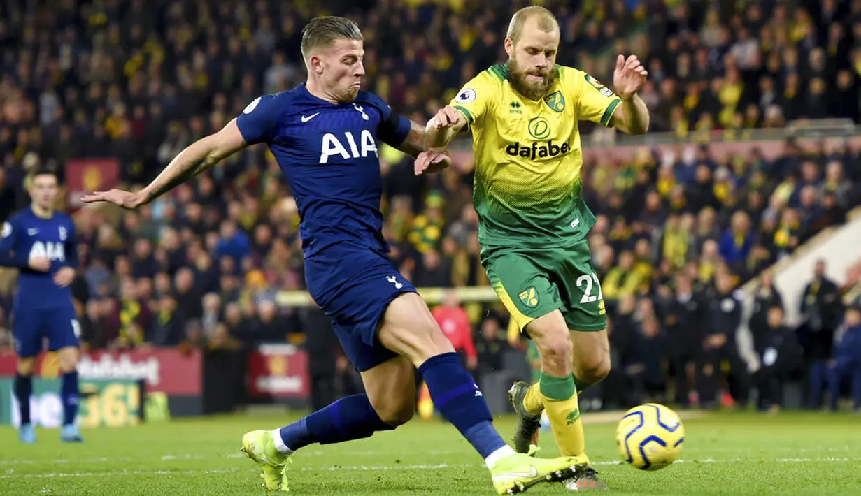 Bek Tottenham Hotspur, Toby Alderweireld, berebut bola dengan striker Norwich City, Teemu Pukki, pada laga Premier League 2019 di Stadion Carrow Road, Sabtu (28/12). Kedua tim bermain imbang 2-2. (AP/Joe Giddens)