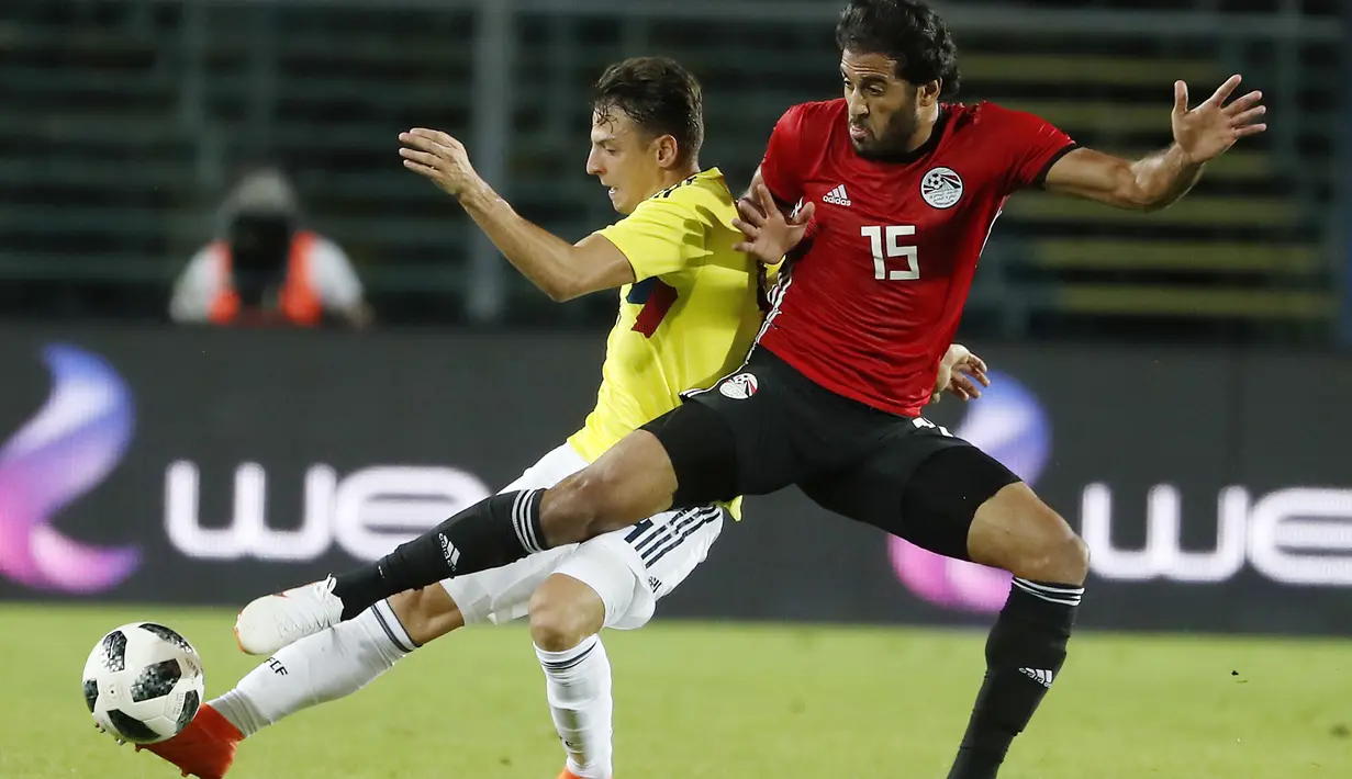 Pemain Kolombia, Santiago Arias (kiri) berusaha melewati adangan pemain Mesir, Marwan Mohsen pada laga uji coba di "Atleti Azzurri d'Italia Stadium”, Bergamo, (1/6/2018). Mesir dan Kolombia bermain imbang 0-0. (AP/Antonio Calanni)