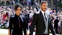 Legenda Timnas Inggris, David Beckham, bersama istrinya Victoria Beckham saat menghadiri upacara pernikahan Pangeran Harry dan Meghan Markle di St George Chapel di kastil Windsor, (19/5/2018). (Photo by Chris Radburn / POOL / AFP)