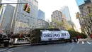 Truk trailer bak terbuka membawa pohon Natal untuk didirikan di Rockefeller Center, New York pada 9 November 2019. Pohon cemara Norwegia tersebut memiliki tinggi 77 kaki atau 12 meter dengan berat 77 ton yang akan dinyalakan pada 4 Desember mendatang. (Diane Bondareff/AP Images for Tishman Speyer)