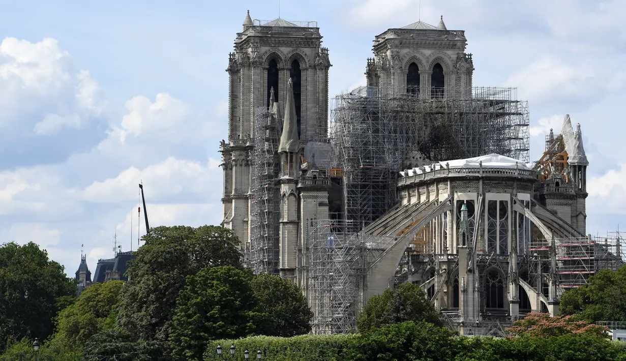 Pemandangan Katedral Notre Dame yang tengah menjalani restorasi setelah rusak parah akibat kebakaran hebat, Paris, Prancis, Minggu (14/7/2019). Sekitar 100 orang melakukan restorasi yang dilakukan oleh tim pemulihan katedral. (ALAIN JOCARD/AFP)