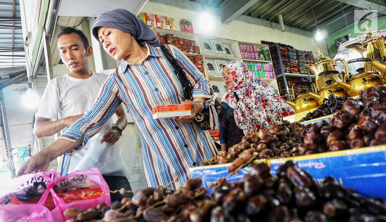Pembeli memilih kurma yang dijual di Pasar Tanah Abang, Jakarta, Kamis (2/5). Menjelang bulan Ramadan, permintaan buah kurma meningkat dua kali lipat dibanding hari biasa. (Liputan6.com/JohanTallo)