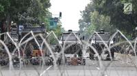 Kawat berduri dipasangkan di depan Gedung Mahkamah Konstitusi (MK), Jakarta, Rabu (26/6/2019). Kepolisian memperketat penjagaan di sekitar Gedung MK dengan kawat berduri, kendaraan lapis baja, serta ratusan personel. (merdeka.com/Iqbal S. Nugroho)