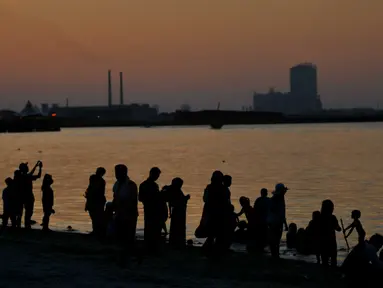 Sejumlah Pengungjung menikmati wisata di pantai Ancol, Jakarta, (31/12). Pemprov DKI Jakarta menyarankan untuk warga Jakarta yang ingin merayakan malam pergantian tahun di pusatkan di Pantai Ancol. (Liputan6.com/Gempur M Surya)