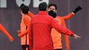 Penyerang Barcelona, Lionel Messi berbincang dengan pelatih Ernesto Valverde saat latihan di Joan Gamper Sports Center di Sant Joan Despi, Spanyol (13/3). Barcelona akan melawan Chelsea pada leg kedua babak 16 besar Liga Champions. (AFP Photo/Lluis Gene)