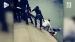 Belasan pejalan kaki berhasil menyelamatkan seorang gadis yang tenggelam di sungai di Sichuan, China.
