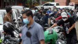 Warga antre untuk melakukan uji emisi kendaraan bermotor secara gratis di Bengkel Dinas Lingkungan Hidup DKI Jakarta, Kamis (4/11/2021). Pemprov DKI Jakarta mengumumkan akan menerapkan sanksi tilang bagi kendaraan bermotor yang tidak lulus atau belum melakukan uji emisi. (merdeka.com/Imam Buhori)