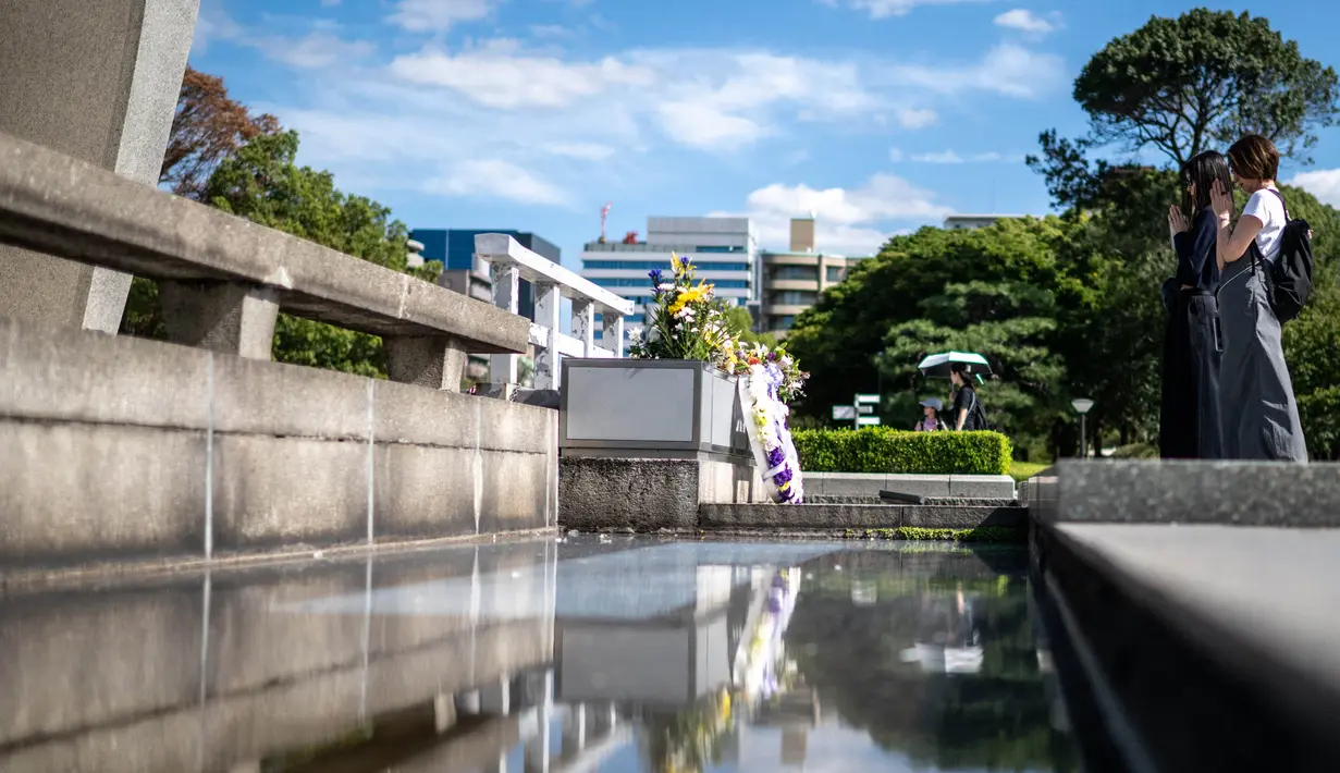 Orang-orang berdoa di depan cenotaph di Taman Peringatan Perdamaian Hiroshima di kota Hiroshima pada tanggal Satu 12 Oktober 2024. (Philip FONG/AFP)