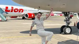 Luna Maya tampil kasual memakai seragam warna krem khas pramugari Super Air Jet dan sneakers putih. (FOTO: instagram.com/pramugarisuperairjet)