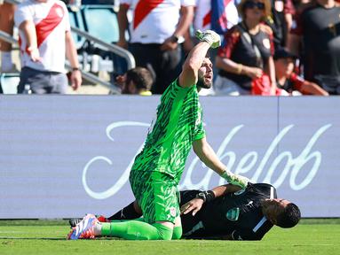 Kiper Kanada, Maxime Crepeau meminta pertolongan saat asisten wasit Humberto Panjoj mengalami pingsan saat laga Grup A Copa America 2024 antara Peru melawan Kanada di Children's Mercy Park, Kansas City, Kansas, Selasa (25/06/2024) waktu setempat. (AFP/Getty Images/Hector Vivas)