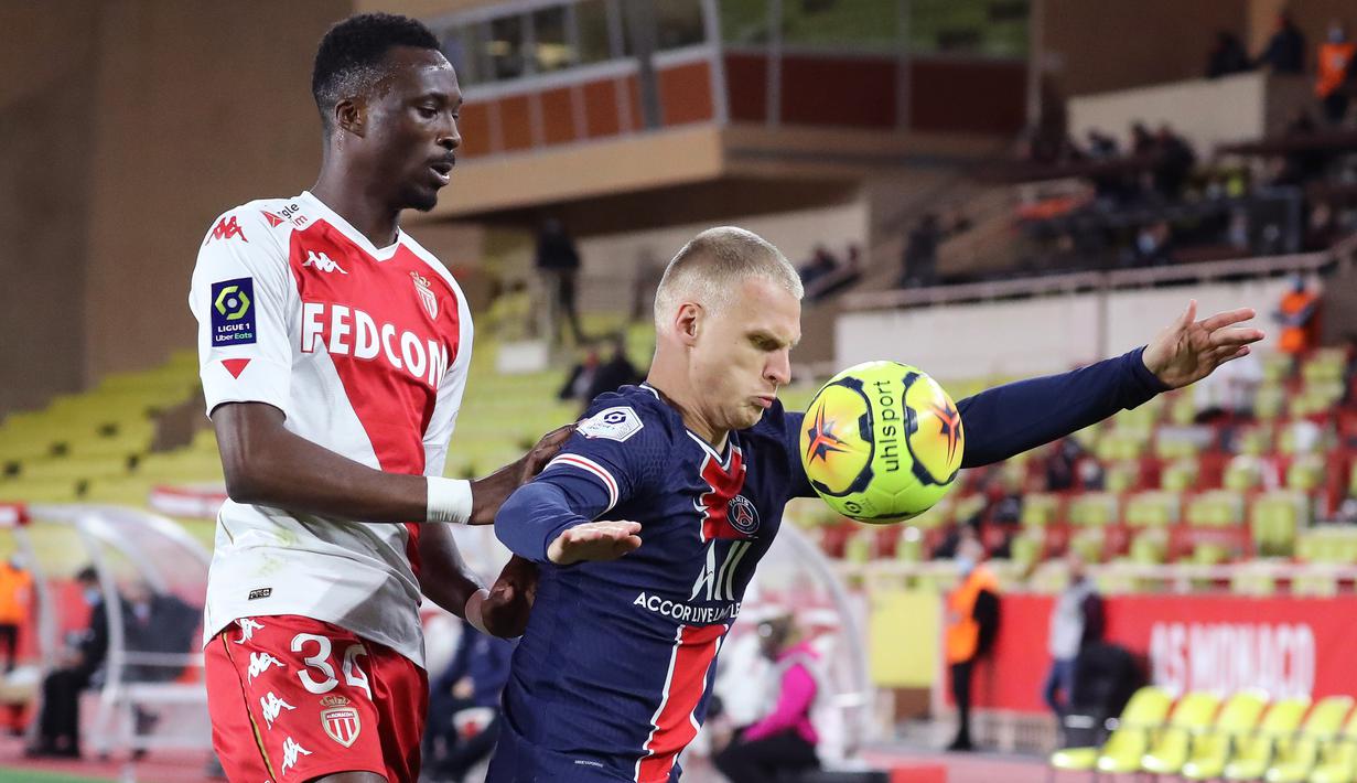 Bek PSG, Mitchel Bakker, Berebut bola dengan bek AS Monaco, Chrislain Matsima, pada laga lanjutan Liga Prancis di Stadion Stade Louis II, Sabtu (21/11/2020) dini hari WIB. PSG takluk 2-3 oleh AS Monaco. (AFP/Valery Hache)