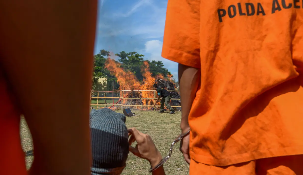 Tersangka dihadirkan saat pemusnahan ganja 1,8 ton dan 10 kilogram metamfetamin di Mapolda Aceh, Banda Aceh, provinsi Aceh (24/8). Ganja tersebut ditemukan sepanjang tahun 2017. (AFP Photo/Chaideer Mahyuddin)