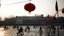 Sejumlah warga tampak menikmat bermain ice skating atau seluncur es di atas sungai yang telah membeku di Beijing, Jumat (1/1). Semenjak membeku, sungai di Beijing ini menjadi objek wisata es dadakan yang banyak diminati wisatawan.  (AFP/Fred Dufour) 