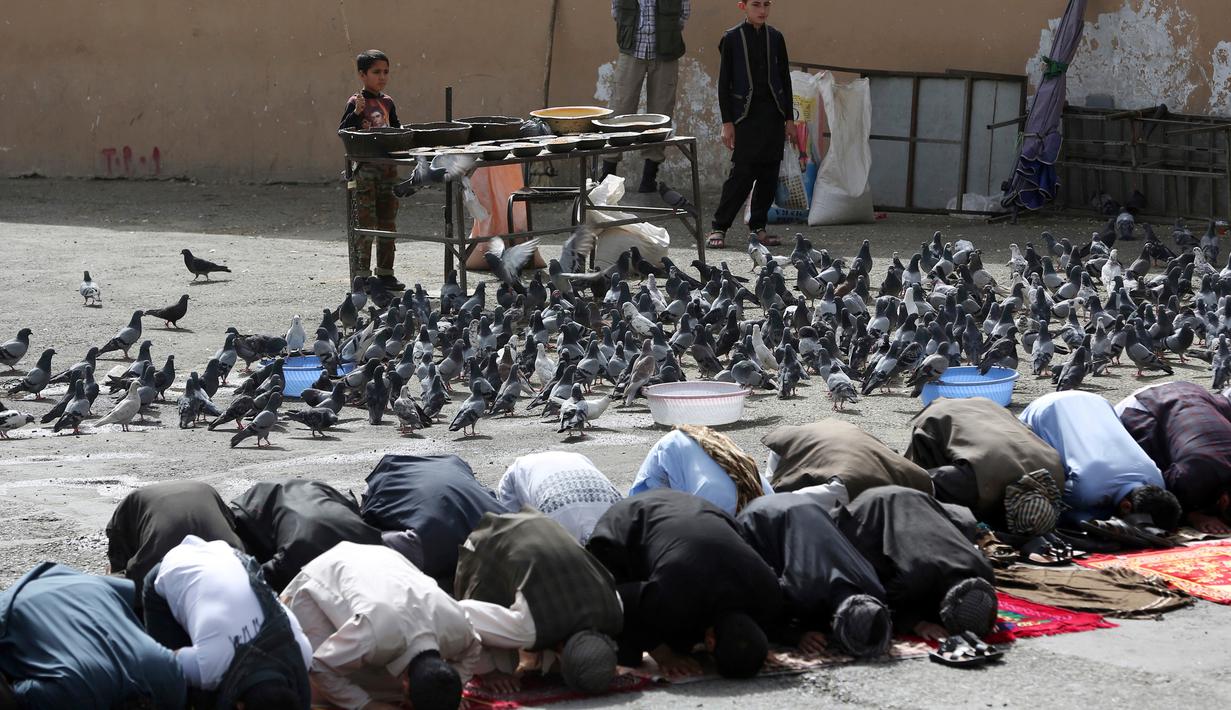 Sejumlah warga Palestina melaksanakan salat Idul Fitri 1439 H di luar masjid Shah-e-Dushamshera di Kabul, Afghanistan, Jumat, (15/6). (AP Photo/Massoud Hossaini)