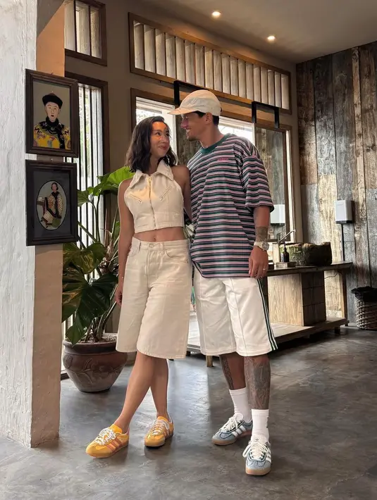 Inspirasi tampilan penuh gaya untuk liburan, Jennifer mengenakan collar sleeveless crop top dan celana ¾. Penampilannya dilengkapi dengan sneakers warna kuning. Sementara Irfan tampil mengenakan striped tee, shorts, cap, dan sneakers.  [@jenniferbachdim].