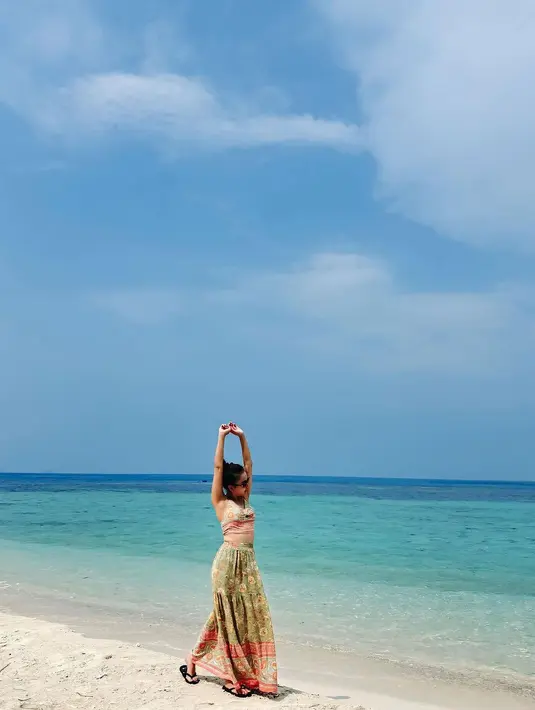 Penampilannya kemudian dilengkapi dengan kacamata hitam dan sandal jepit hitam polos.  [@ayutingting92].