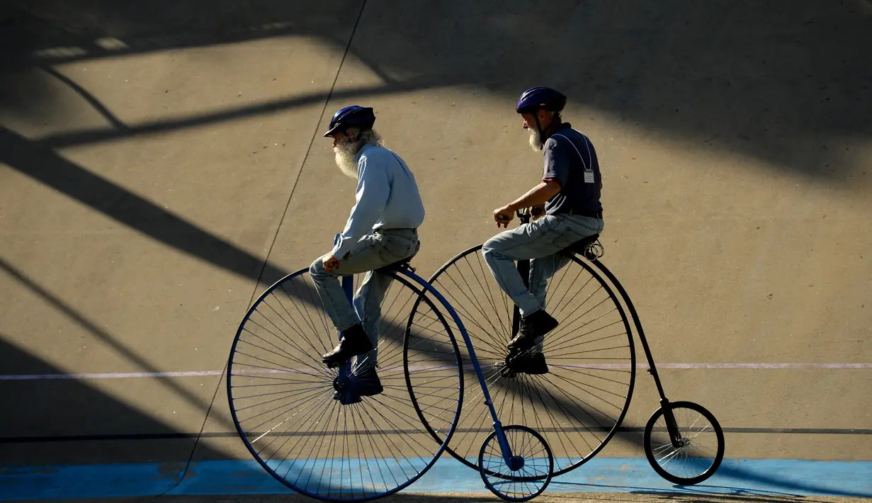 Dua pria mengendarai sepeda klasik saat kegiatan Sydney Classic Bicycle Show 2017 di Canterbury Velodrome di Sydney (6/5). Kegiatan ini sudah dijalankan oleh klub sepeda Dulwich Hill sejak 1908. (AFP Photo/Peter Parks)