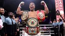 Petinju Anthony Joshua merayakan kemenangannya atas Andy Ruiz Jr dalam kejuaraan tinju kelas berat dunia di Diriyah Arena, Riyadh, Arab Saudi, Minggu (8/12/2019). Anthony Joshua menang angka mutlak atas Andy Ruiz Jr. (Nick Potts/PA via AP)