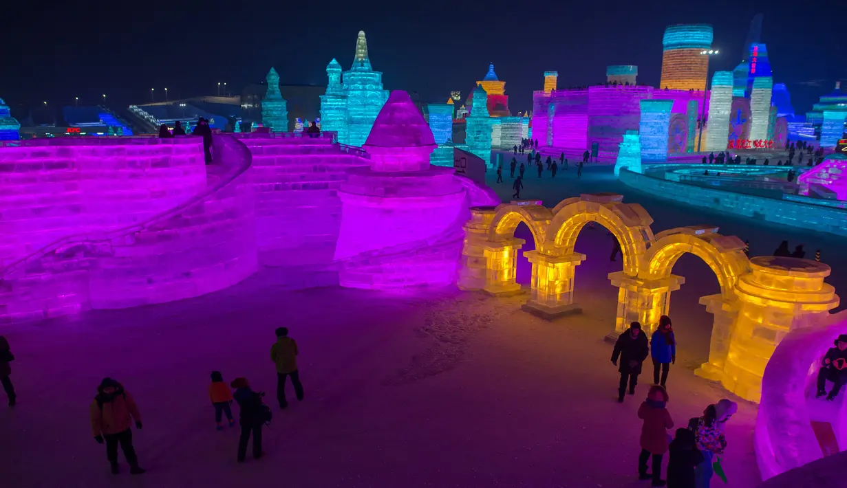 Pengunjung melihat keindahan warna-warni yang terbuat dari es saat Festival Es dan Salju di Harbin, Tiongkok, Rabu (4/1). Event tahunan tersebut merupakan salah salah satu festival yang cukup dinanti oleh wisatawan.( AFP PHOTO / Nicolas ASFOURI)