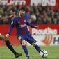 Pemain Barcelona, Lionel Messi (kanan) mengecoh pemain Sevilla, N'zonzi pada laga La Liga Santander di Sanchez Pizjuan stadium, (31/3/2018). Barcelona bermain imbang 2-2 dengan Sevilla. (AP/Miguel Morenatti)