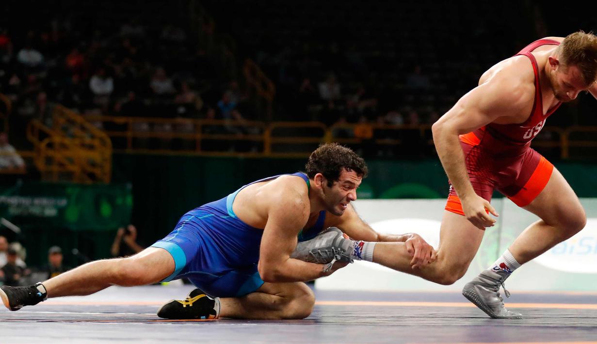 David Taylor dari AS (kanan) saat bertanding melawan Aleksander Gostiev dari Azerbaijan selama pertandingan gulat 86 kilogram di Freestyle Wrestling World Cup di Iowa City, Iowa (8/4). (AP Photo/Charlie Neibergall)