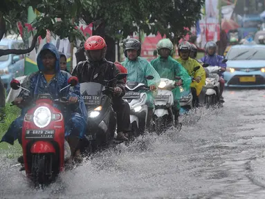 Pengendara bermotor melewati banjir di Jalan Cinere Raya (depan Mall Cinere), Depok, Jawa Barat, Minggu (31/3). Banjir terjadi akibat sistem drainase yang buruk. (merdeka.com/Arie Basuki)