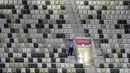 Seorang petugas keamanan mengawasi stadion yang kosong sebelum upacara pembukaan Olimpiade Tokyo 2020 di Olympic Stadium di Tokyo, Jumat (23/7/2021). Upacara pembukaan Olimpiade Tokyo yang berlangsung dalam era pandemi digelar tanpa penonton.  (AP Photo/David J. Phillip)