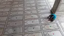 Pengurus menempelkan stiker di lantai bagi jemaah agar menjaga jarak selama salat ketika Masjid Jama dibuka kembali setelah pelonggaran lockdown di kawasan Kota Tua Delhi, Selasa (7/7/2020). India pada 6 Juli menjadi negara dengan jumlah virus corona tertinggi ketiga di dunia. (XAVIER GALIANA/AFP)
