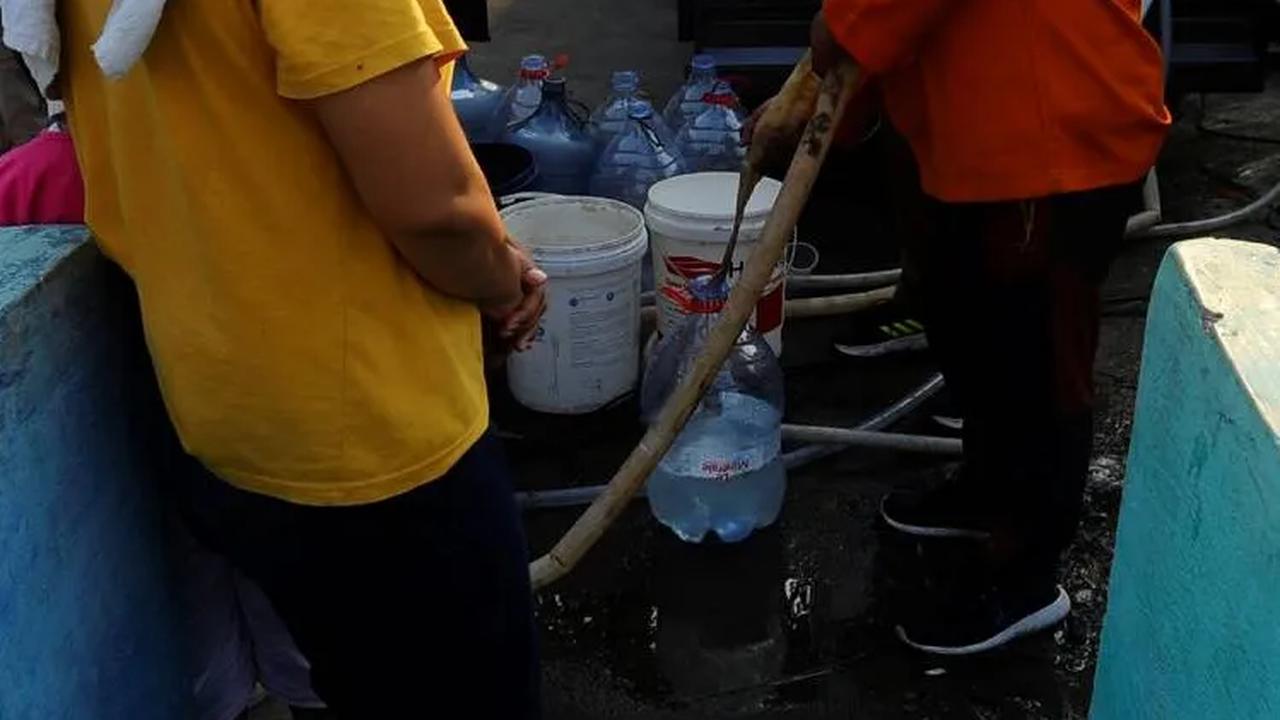 Petugas BPBD Tangerang Selatan saat melayani warga yang mengantre mengisi air bersih.